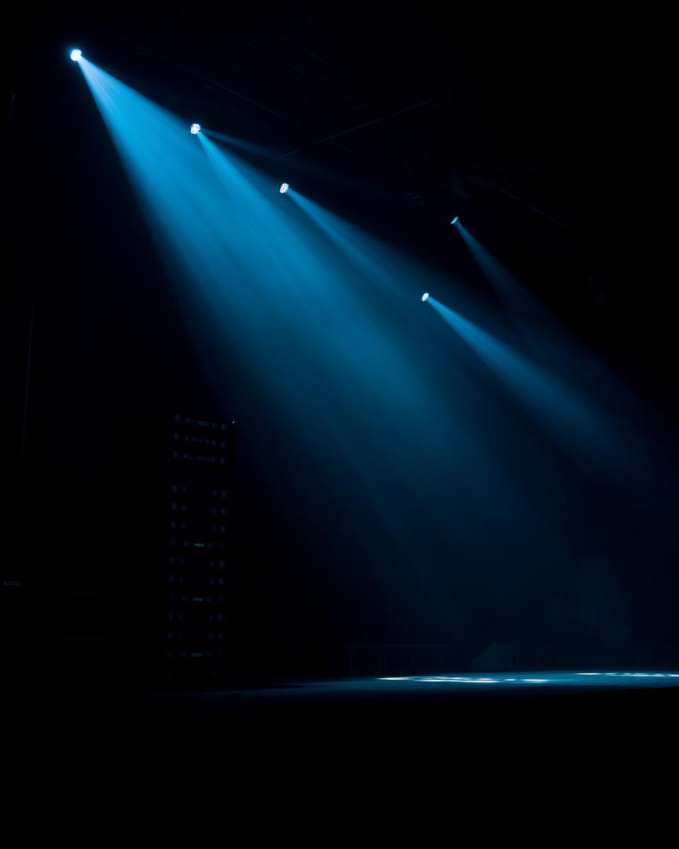 Concert stage lit with cyan spotlights
